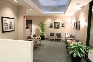 Moats Dental waiting room with framed portraits on the wall and chairs for patients