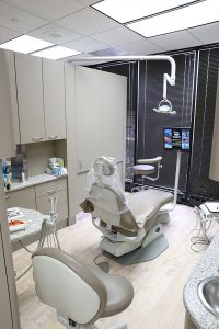 Moats Dental examination room with a tv and dental tools by the patient's chair